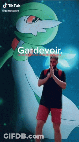 A Man Is Standing In Front Of A Pokemon Named Gardevoir GIF