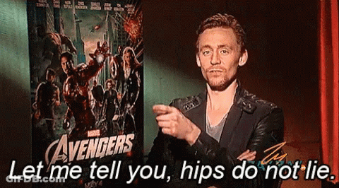 A Man Is Standing In Front Of A Poster For The Avengers GIF