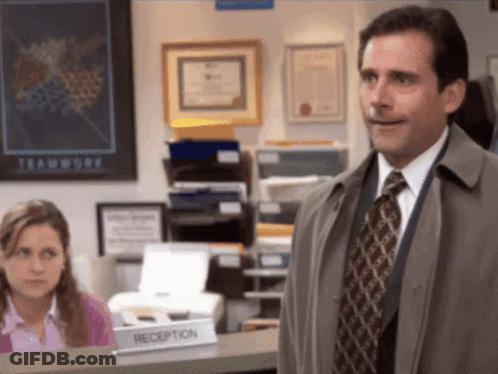 A Man Is Standing In Front Of A Reception Desk GIF