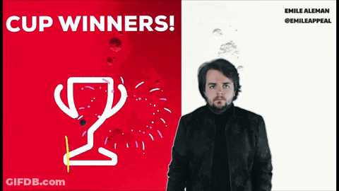A Man Is Standing In Front Of A Red And White Poster That Says Cup Winners GIF