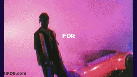 A Man Is Standing In Front Of A Red Car With The Words `` For '' Written Above Him . GIF