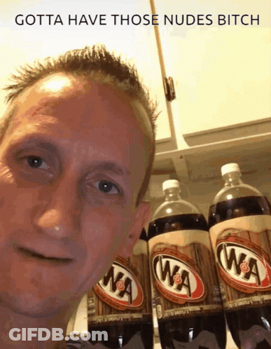 A Man Is Standing In Front Of A Row Of Wa Cola Bottles GIF