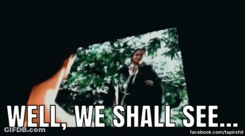 A Man Is Standing In Front Of A Screen With The Words `` Well , We Shall See ... '' Written On It . GIF
