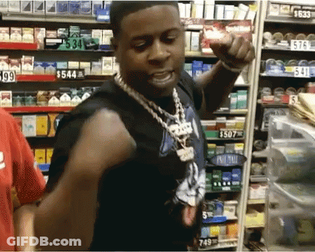 A Man Is Standing In Front Of A Shelf With A Price Tag Of $ 549 GIF