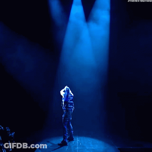 A Man Is Standing In Front Of A Sign That Says Damian Presley GIF