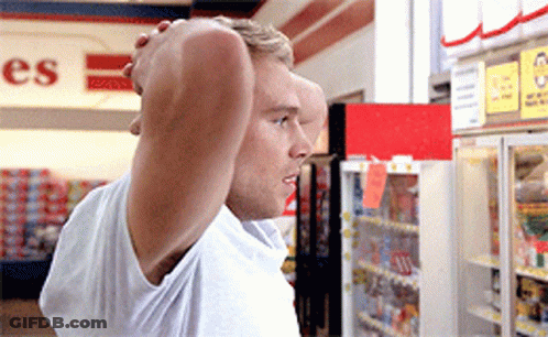 A Man Is Standing In Front Of A Sign That Says ' Es ' On It GIF