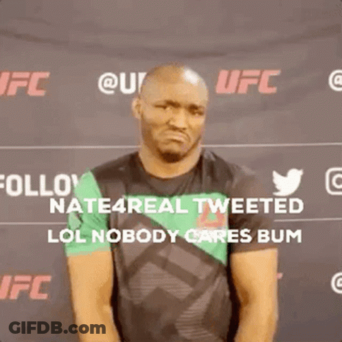 A Man Is Standing In Front Of A Sign That Says Follow Nate4real Tweeted Lol Nobody Cares Bum GIF
