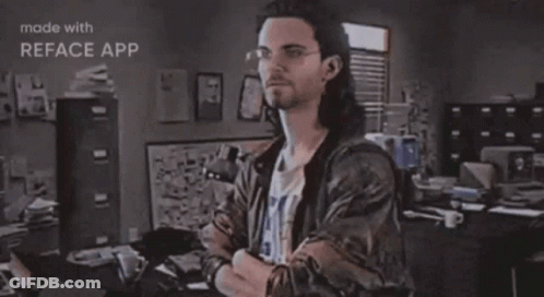 A Man Is Standing In Front Of A Sign That Says Hackerman GIF