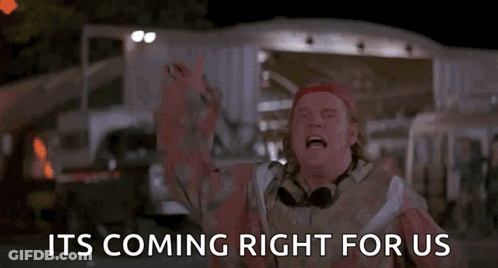 A Man Is Standing In Front Of A Sign That Says `` It 'S Coming Right For Us '' GIF