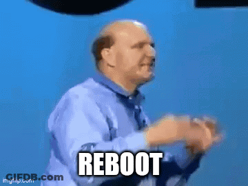 A Man Is Standing In Front Of A Sign That Says Microsoft Windows Reboot GIF