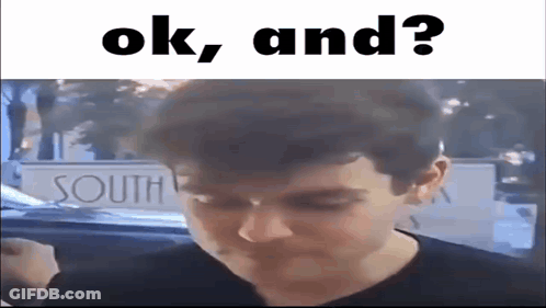 A Man Is Standing In Front Of A Sign That Says `` Ok , And ? '' . GIF