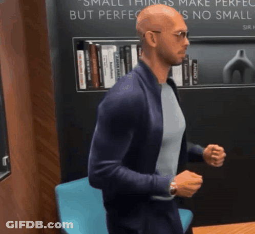 A Man Is Standing In Front Of A Sign That Says Small Things Make Perfect But Perfection Is No Small Thing GIF