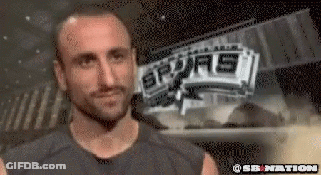 A Man Is Standing In Front Of A Sign That Says Spurs GIF