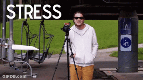 A Man Is Standing In Front Of A Sign That Says " Stress " GIF