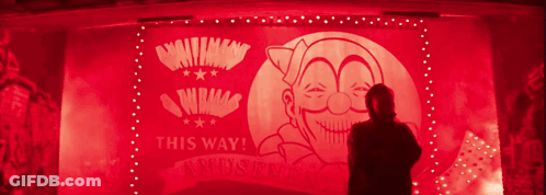 A Man Is Standing In Front Of A Sign That Says This Way On It GIF