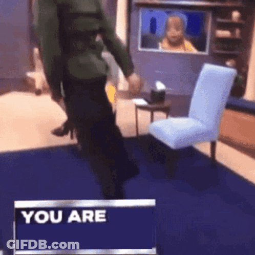 A Man Is Standing In Front Of A Sign That Says " You Are " GIF