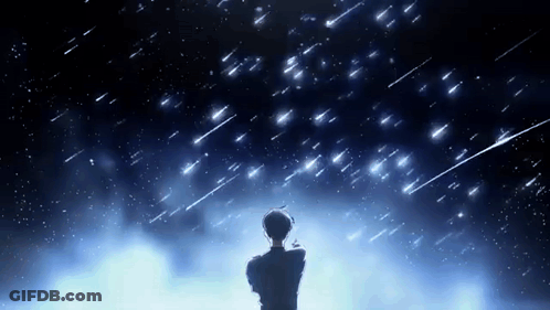 A Man Is Standing In Front Of A Starry Night Sky Looking Up At The Stars . GIF
