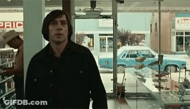 A Man Is Standing In Front Of A Store That Has The Word Pric On It GIF