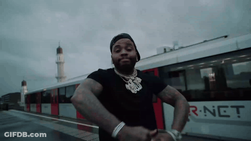 A Man Is Standing In Front Of A Train That Says R-Net On The Side GIF