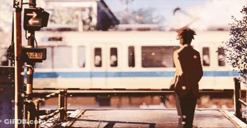 A Man Is Standing In Front Of A Train With A Sign That Says ' N ' On It GIF