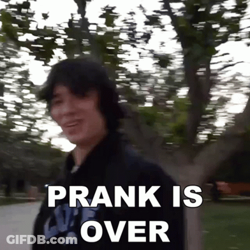 A Man Is Standing In Front Of A Tree With The Words Prank Is Over Written Below Him GIF