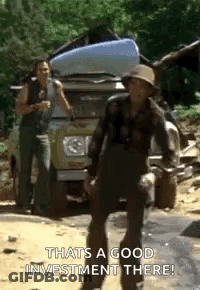 A Man Is Standing In Front Of A Truck With A Bag On The Back . GIF