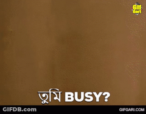 A Man Is Standing In Front Of A Wall And Says " Busy " In A Foreign Language GIF