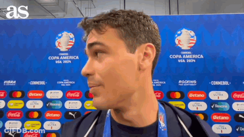 A Man Is Standing In Front Of A Wall That Says Copa America Usa 2024 GIF