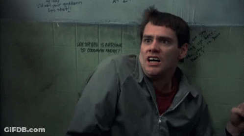 A Man Is Standing In Front Of A Wall That Says " Why The Hell Is Everyone So Goddamn Angry " On It GIF