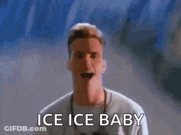 A Man Is Standing In Front Of A Wall With The Words Ice Ice Baby On It . GIF