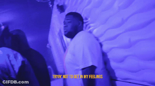 A Man Is Standing In Front Of A Wall With The Words Tryin ' Not To Get In My Feelings On The Bottom GIF