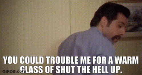 A Man Is Standing In Front Of A Wall With The Words " You Could Trouble Me For A Warm Glass Of Shut The Hell Up " On It GIF