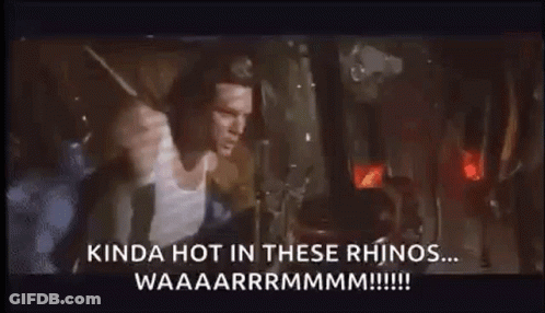 A Man Is Standing In Front Of A Window With A Rhino Coming Out Of It And Screaming . GIF