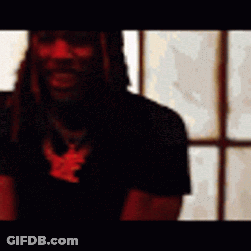 A Man Is Standing In Front Of A Window With His Arms Outstretched In A Blurry Photo . GIF