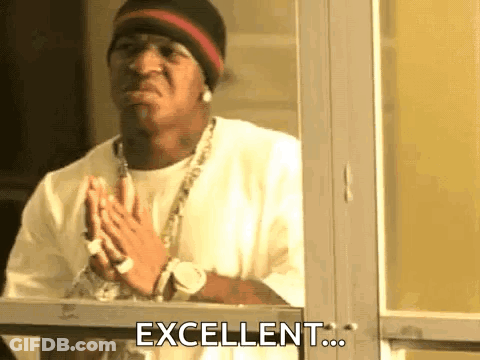 A Man Is Standing In Front Of A Window With His Hands Folded And The Words `` Excellent '' Written On The Window . GIF