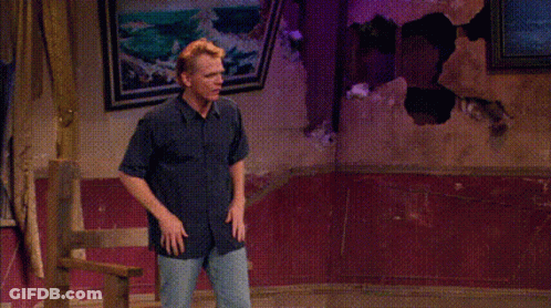 A Man Is Standing In Front Of A Window With His Hands Outstretched And Says Hey GIF