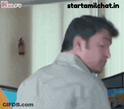A Man Is Standing In Front Of A Window With The Words Starttamilchat.in Written On The Bottom GIF