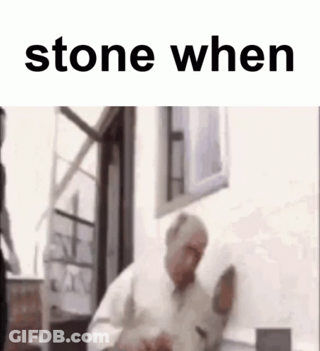 A Man Is Standing In Front Of A Window With The Words `` Stone When '' On The Bottom . GIF