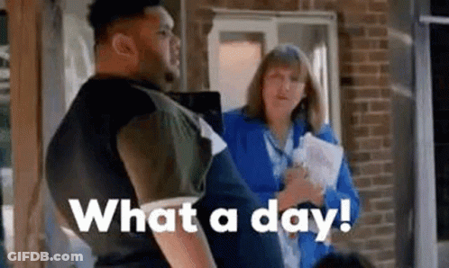 A Man Is Standing In Front Of A Woman Holding A Piece Of Paper And Talking To Her . GIF