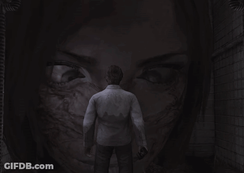 A Man Is Standing In Front Of A Woman 'S Face GIF