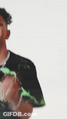 A Man Is Standing In Front Of A Yellow Background GIF