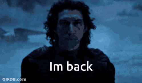 A Man Is Standing In The Dark And The Words Im Back Are Visible GIF