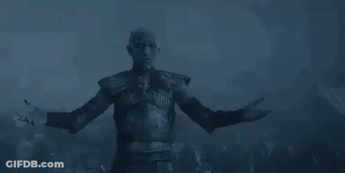 A Man Is Standing In The Dark With His Arms Outstretched . GIF
