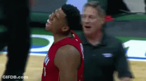 A Man Is Standing Next To A Basketball Player Who Is Looking Up At The Sky . GIF