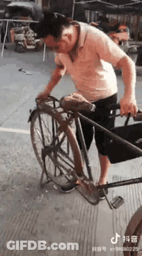 A Man Is Standing Next To A Bicycle On A Sidewalk . GIF