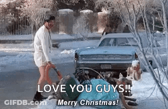 A Man Is Standing Next To A Car In The Snow Holding A Shovel . GIF