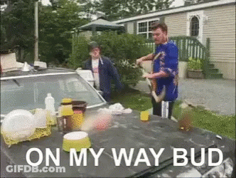 A Man Is Standing Next To A Car With The Words On My Way Bud GIF