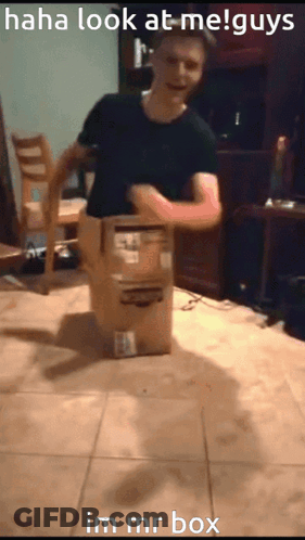A Man Is Standing Next To A Cardboard Box That Says Im Mr Box On It GIF