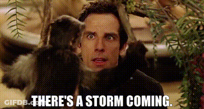 A Man Is Standing Next To A Monkey With The Words `` There 'S A Storm Coming '' Written On It . GIF