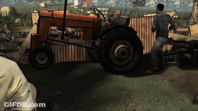 A Man Is Standing Next To A Red Tractor GIF